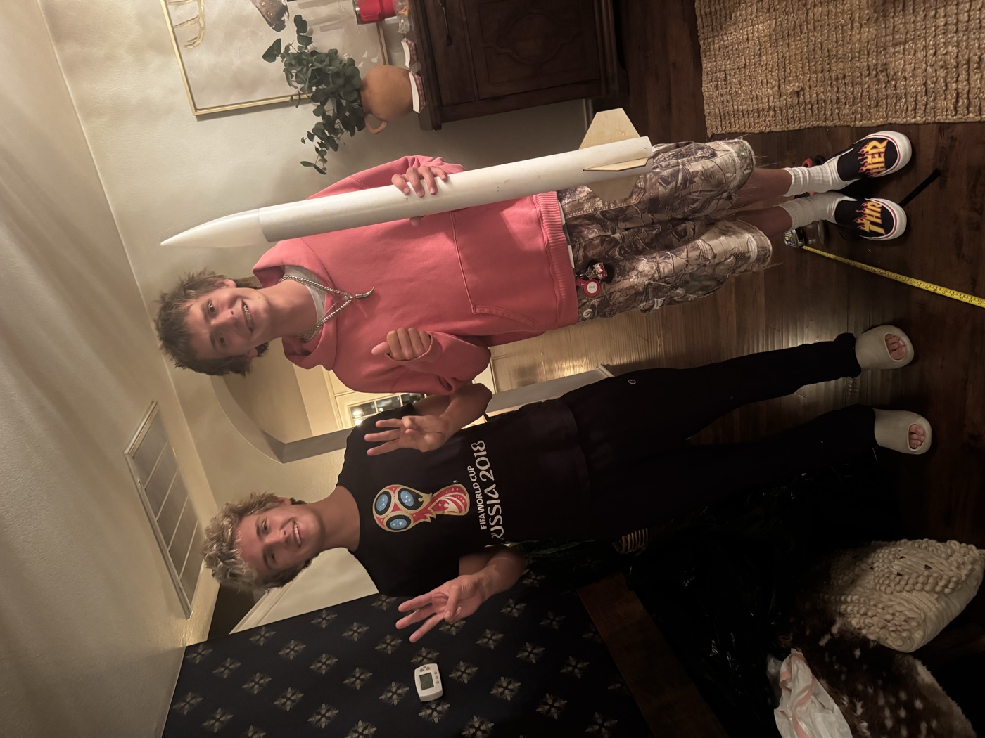 Noah and a club member holding a finished rocket